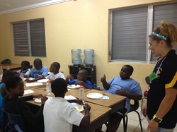 Kristen Kochenour volunteering with students in East End, Bahamas for the Healthy Head to Toe Camp. Kristen is pictured here with her students. Childhood Nutrition.
